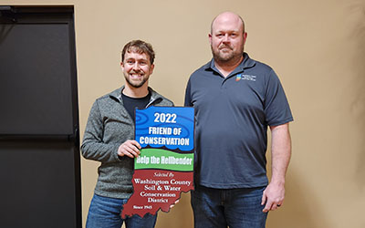 Help the Hellbender program coordinator Nick Burgmeier accepts the Friend of Conservation Award from the Washington County Soil and Water Conservation District