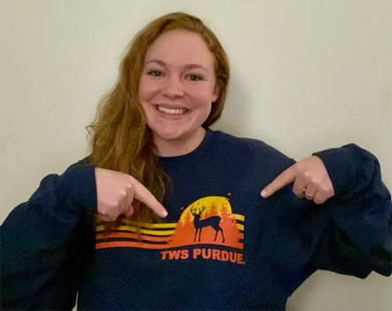 Amanda Heltzel pointing at the TWS Purdue logo on her shirt