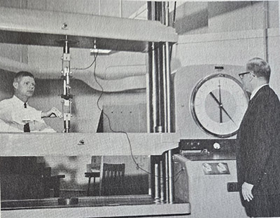 Dr. Michael Hunt (left) and Dr. Carl Eckelman test the strength of dowel joint in the study of furniture engineering design.