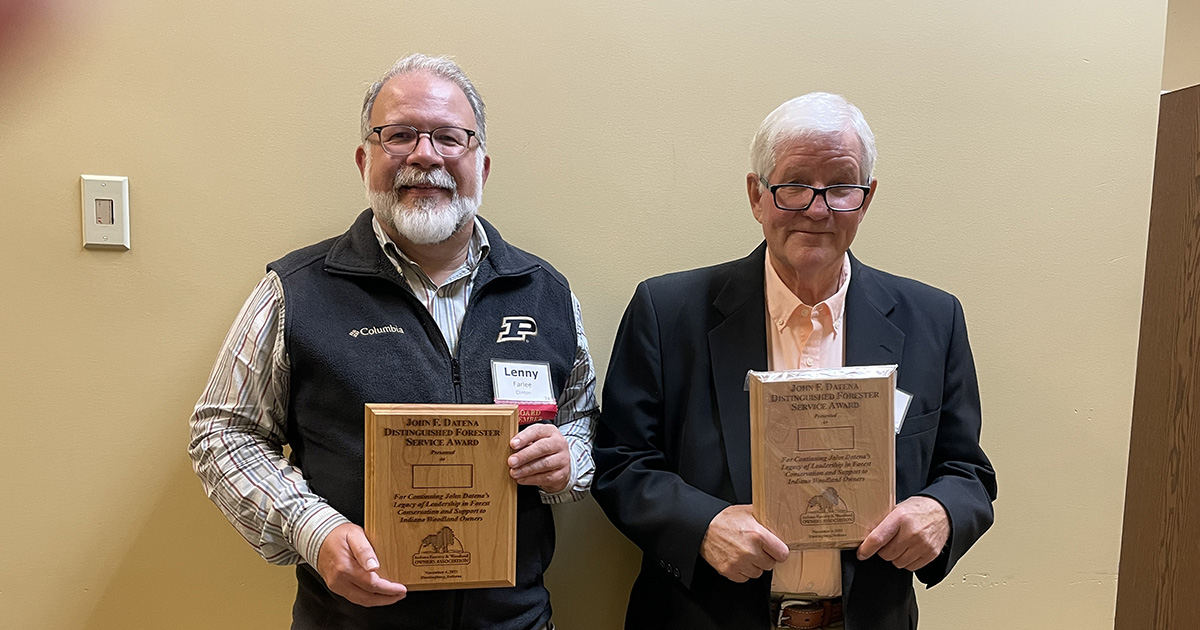 Lenny Farlee (left) and Jack Nelson (right) accept the Datena Distinguished Forester Award at the Indiana Woodland Owner conference.
