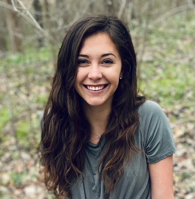 Jada Laycock sitting on a rock in the forest