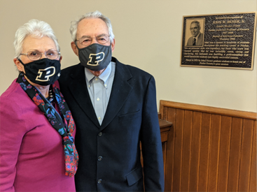 John and Joyce Moser standing in front of Moser award