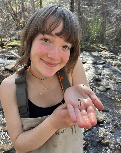 Alyssa Johnson shows off a salamander she found while herping