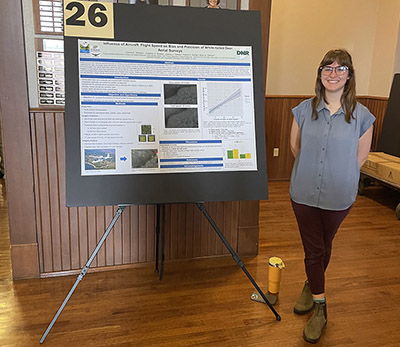 Emma Johnson stands next to her research poster at the FNR Poster Competition