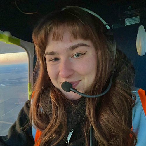 Emma Johnson receives her Fenske Award at the Midwest Fish and Wildlife Conference; Johnson stands next to the Sky Arrow plane her team uses for research. 