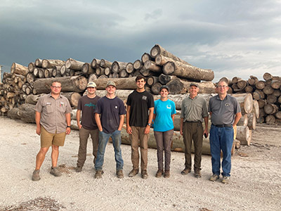 Isaac Johnson, his fellow interns and foresters Mikaela Scherzinger and Ron Rathfon along with Dr. Mike Saunders at the Werner Sawmill. 