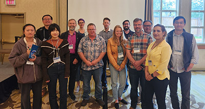 Dr. John Kershaw in 2023 with several UNB students from the past 30 years.