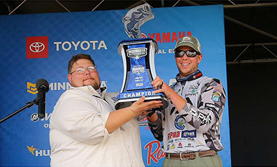Tom Lang hands off the trophy at the Toyota Bassmaster Texas Fest