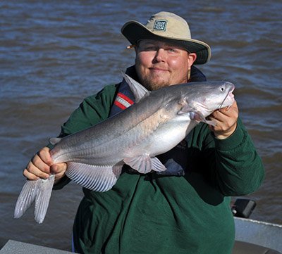 Tom Lang holds a fish