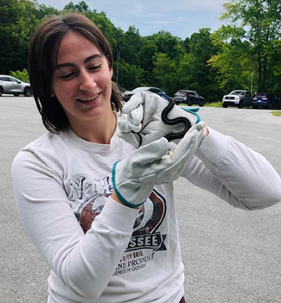 Amber Laughner holds a small garter snake