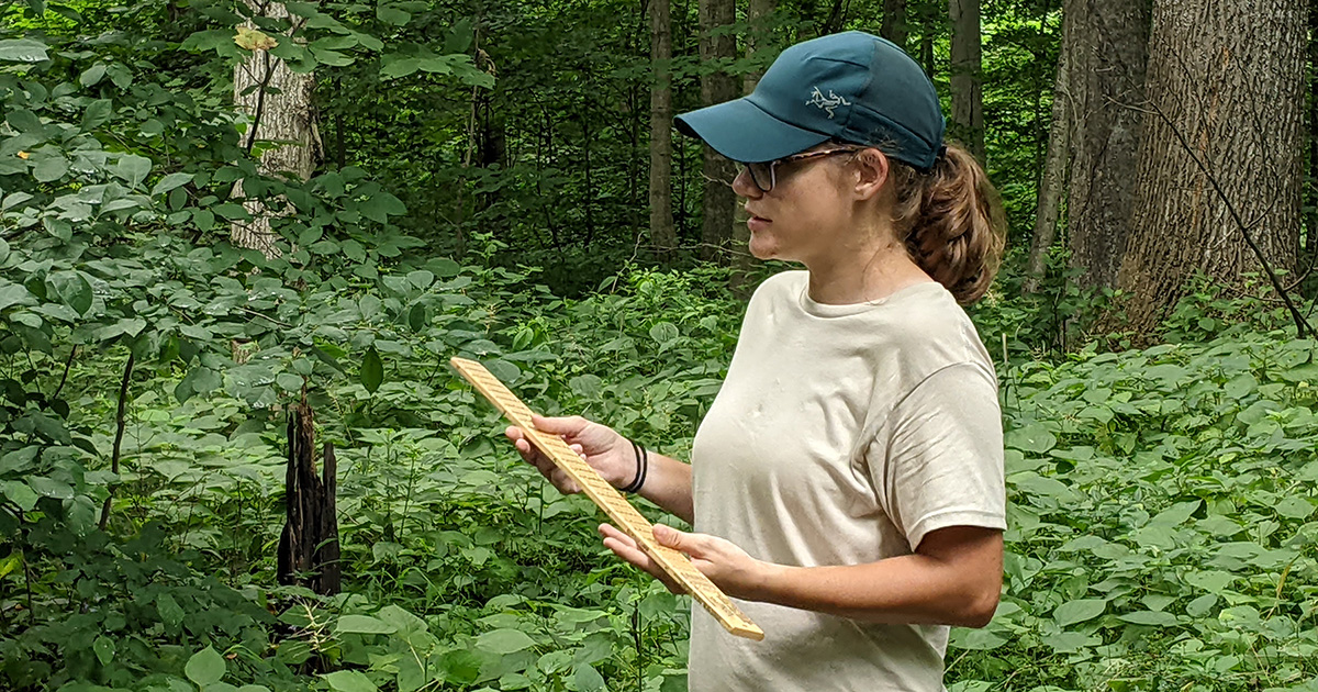 Lauren Laux with a Biltmore stick, teaching citizens how to measure trees at Wednesdays in the Wild