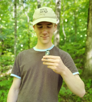 Lucas Wilson holding a small amphibian