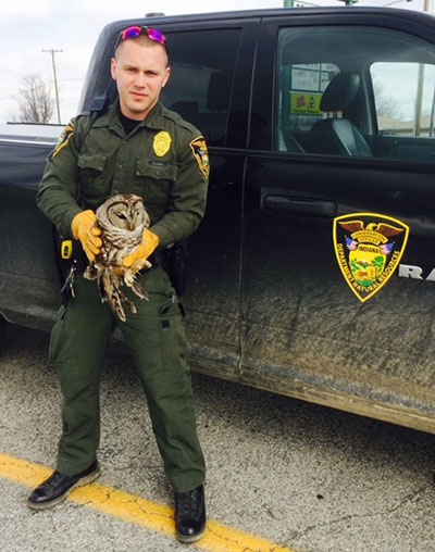 Nathan Lutz as a conservation officer with an owl