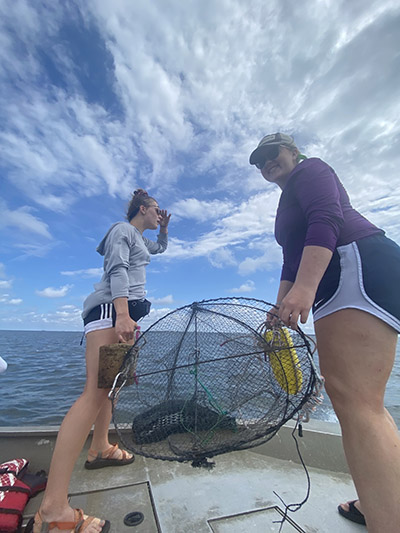 Senior Emily Ragsdale prepares to toss a crab pot into the water