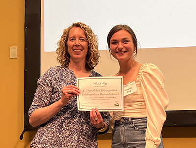 Amanda King receives her certificate for the L. David Mech Distinguished Undergraduate Research Award from Dr. Elizabeth Flaherty