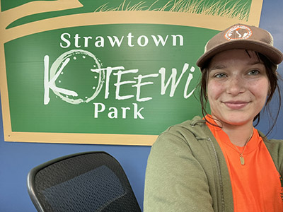Madi Medley takes a selfie in front of the sign on her first day at Strawtown Koteewi Park.