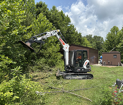 Madi Medley training on the excavator with a forestry mulching attachment. 