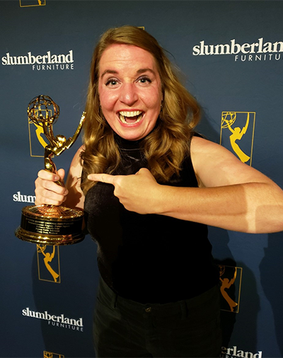 Megan Benage holding an emmy