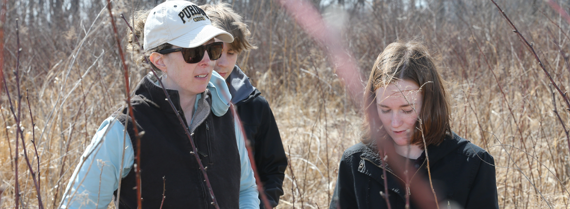 Liz Flaherty in field with students, wildlife ecology class, Purdue Forestry and Natural Resources.