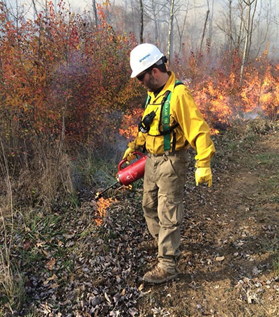 Trent Osmon lights a prescribed fire