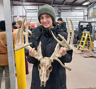 Lydia Pultorak holds a deer skull