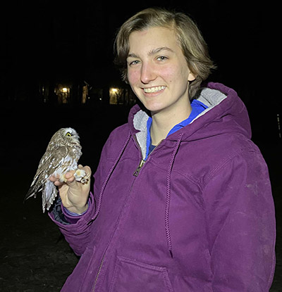 Lydia Pultorak holds a Northern Saw-whet Owl