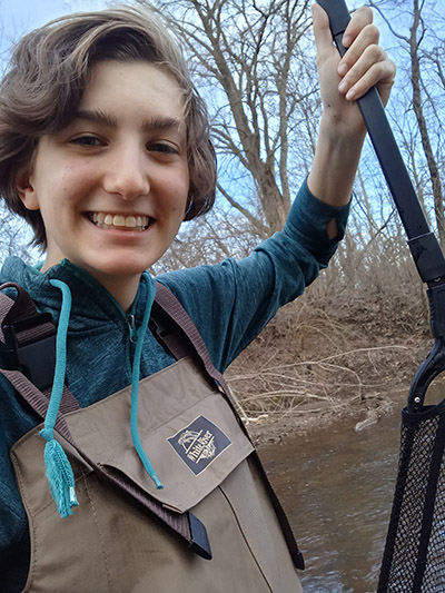 Lydia Pultorak wears waders in the water