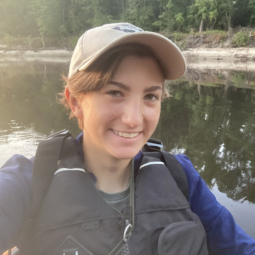 Lydia Pultorak holds a pair of binoculars while conducting a bird survey; a nest of red-winged black bird eggs; Lydia holds an eastern ribbon snake