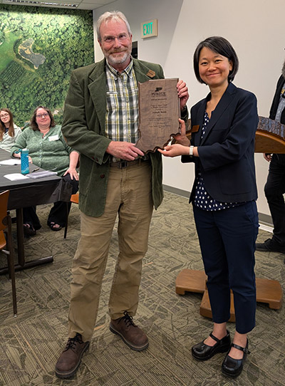 Dr. Joe Robb is presented the Chase S. Osborn Award plaque by Dr. Zhao Ma.