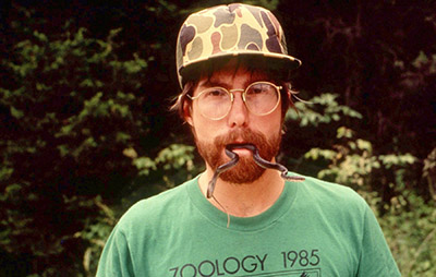 Dr. Joe Robb holds a snake in his mouth in 1985.