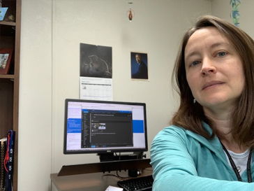 Robin Russell sitting in front of a computer