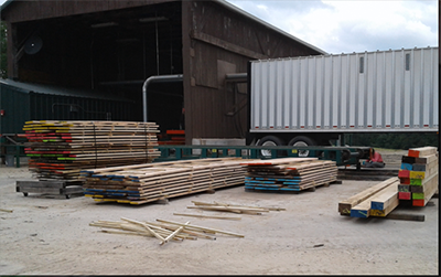 Stack of color coded lumber outside warehouse