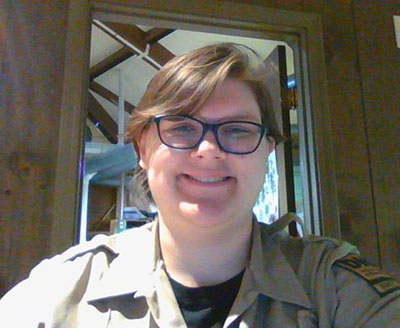 Ren Schiller at their desk in the nature center at Deam Lake