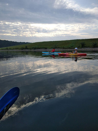 A mother and daughter kayaking at one of Schiller's summer events at Deam Lake