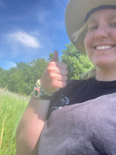 Katie Schouten walking through the Kline Wetland with her employer taking notes on what plant species were present.