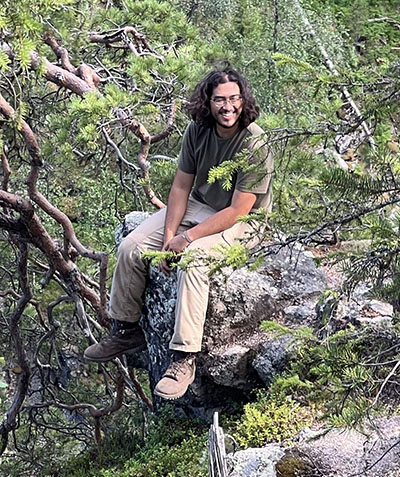 Jonathan Shimizu sits in a forest