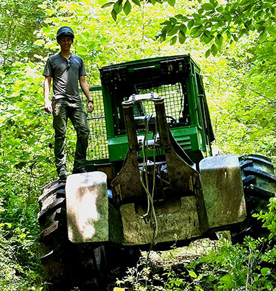 Zane Smoldt on the back of a log skidder