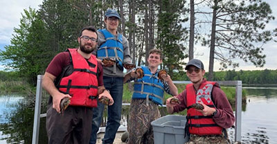 Steven Kelly and classmates catch and measure turtles at Summer Practicum