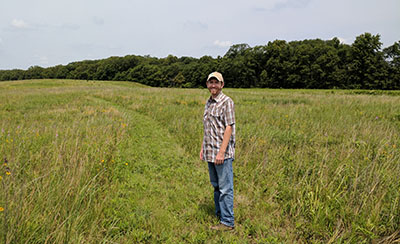 Stoelting stands in a prairie