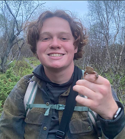 Keegan Abeson, FNR wildlife student, holding frog.