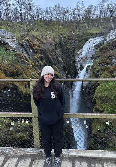 Arlene Polar Pineiro next to a waterfall