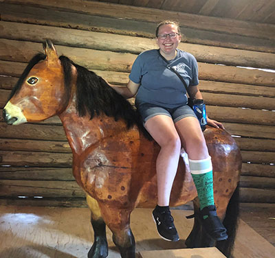 Alex Dudley sitting on a wooden horse