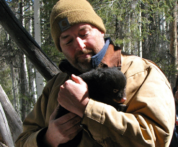 Todd Atwood holding a bear cub