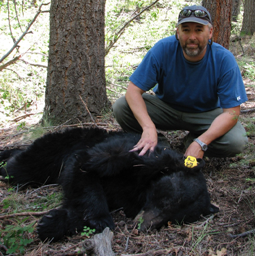 Todd Atwood in the forest with a bear