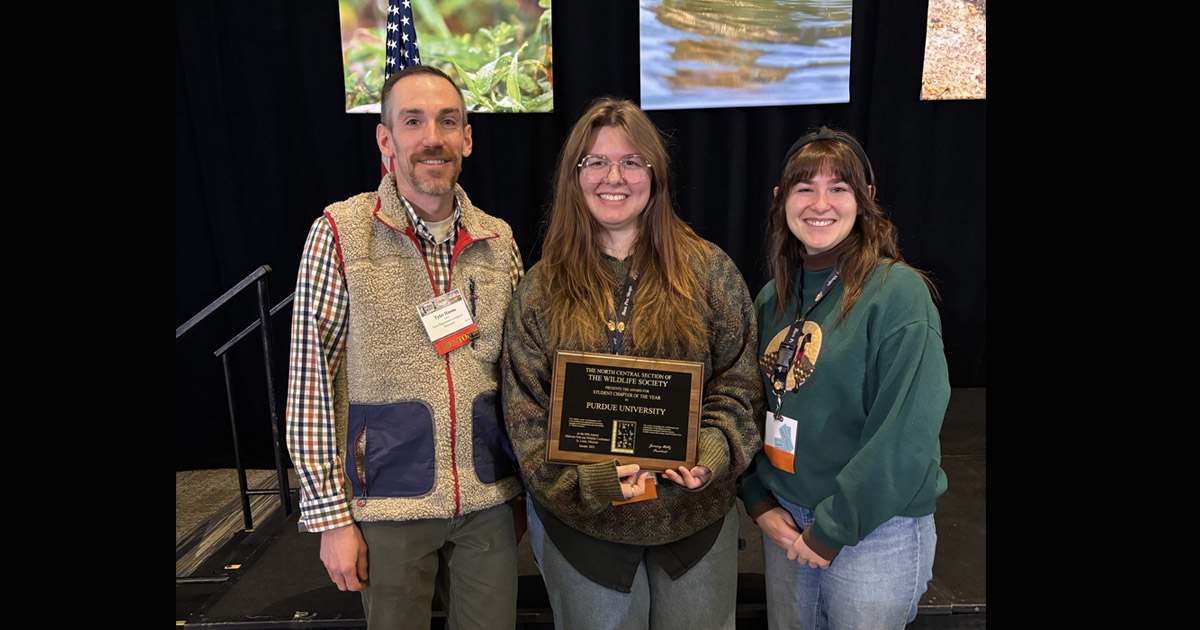 Purdue TWS president Celia Parton and master's student Emma Johnson accept the plaque for North Central Region Student Chapter of the Year at the Midwest Fish and Wildlife Conference.