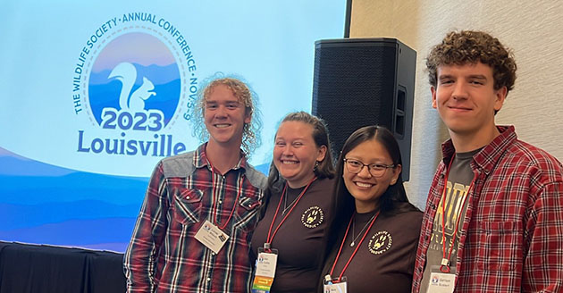 Dr. Pat Zollner, Garrison Sickbert, Lucas Wilson, captain Alex Dudley, Anne Talbot and Dr. Elizabeth Flaherty posed with The Wildlife Society Quiz Bowl Champions plaque and their first place prize, a painting of a viceroy, Kentucky's state butterfly.