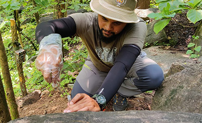 Dr. Abhinav Tyagi gathering samples in the forest