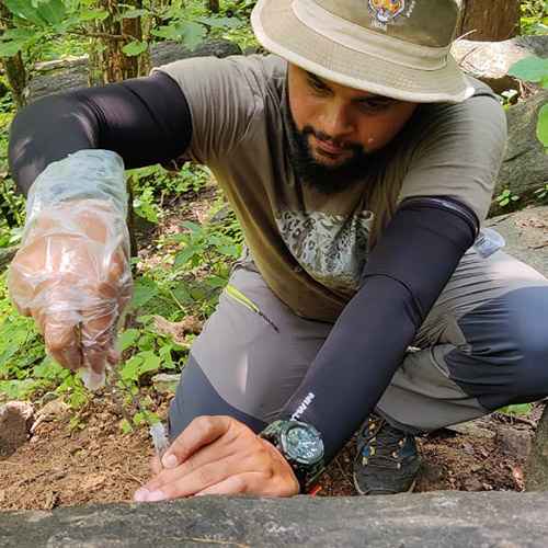 Dr. Abhinav Tyagi talks to forest managers and scientists in a forest in India.
