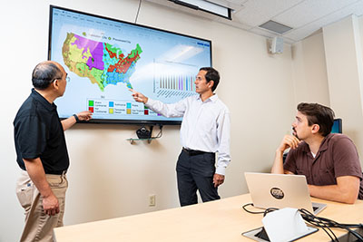 Institute for Digital Forestry director Songlin Fei, from left to right, reviews scope of impact with Daniel Aliaga, associate professor of computer sciences, and co-principal investigator Brady Hardiman, associate professor of forestry and natural resources and environmental and ecological engineering.