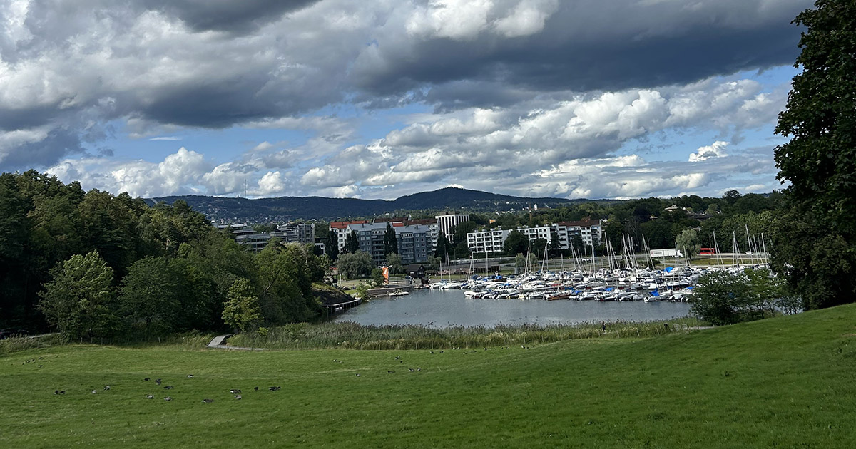 A landscape photo of a water body and boats in Oslo, Norway.